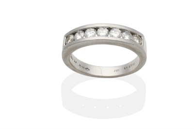 Lot 2147 - A Platinum Diamond Half Hoop Ring, seven channel set round brilliant cut diamonds, on a flat...