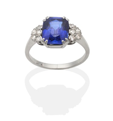 Lot 2149 - A Synthetic Sapphire and Diamond Ring, an octagonal cut synthetic sapphire in a double claw...