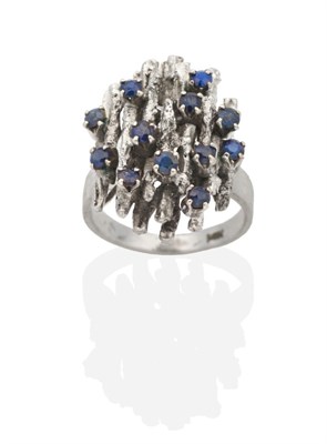 Lot 2000 - A Sapphire Cluster Ring, a textured top set throughout with round cut sapphires, finger size...