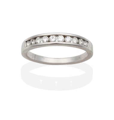 Lot 2020 - An 18 Carat White Gold Diamond Half Hoop Ring, channel set round brilliant cut diamonds to a...