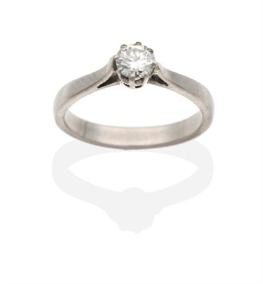 Lot 2025 - A Solitaire Diamond Ring, a round brilliant cut diamond in a claw setting, to tapering...