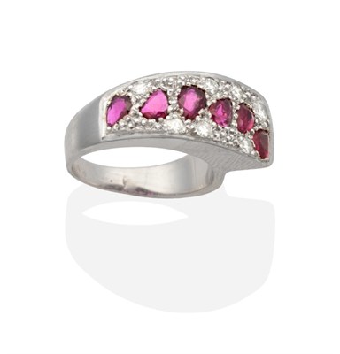 Lot 2034 - A 9 Carat White Gold Ruby and Diamond Ring, a tapering plaque pavé set with pear cut rubies...