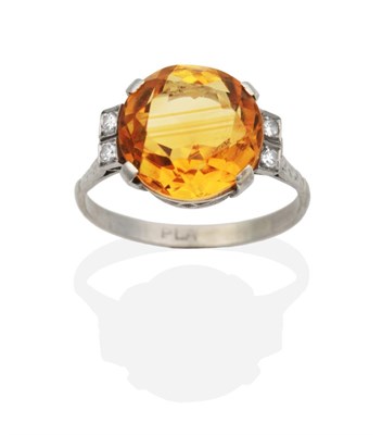 Lot 2041 - An Art Deco Citrine and Diamond Ring, a round cut citrine in a claw setting and spaced by eight-cut