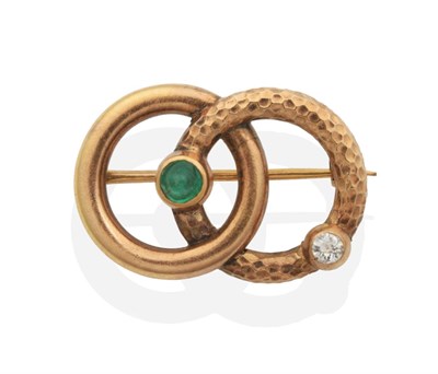 Lot 2057 - An Emerald and Diamond Brooch, formed of interlinked plain polished and textured hoops set with...