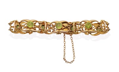 Lot 2059 - An Art Nouveau Peridot Bracelet, round cut peridots in milgrain settings to double whiplash and...