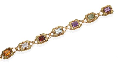 Lot 2071 - A Multi-Gemstone Bracelet, baguette cut vari-coloured quartz, aquamarine and garnet in claw...