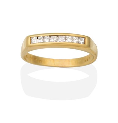 Lot 2082 - An 18 Carat Gold Diamond Ring, channel set with princess cut diamonds, to a tapering shank,...