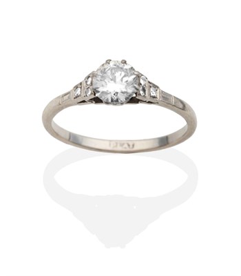 Lot 2089 - A Solitaire Diamond Ring, a round brilliant cut diamond in a claw setting, to diamond set...