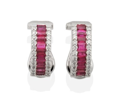 Lot 2093 - A Pair of Ruby and Diamond Half Hoop Earrings, channel set baguette cut rubies flanked by rows...