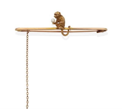 Lot 2105 - A Novelty Monkey Brooch, realistically modelled holding a cultured pearl, with its tail wrapped...