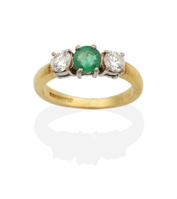 Lot 2114 - An 18 Carat Gold Emerald and Diamond Three Stone Ring, a round cut emerald between two round...