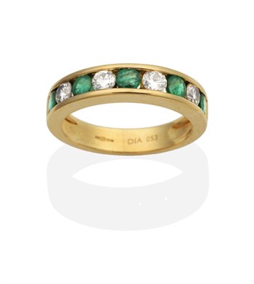 Lot 2117 - An 18 Carat Gold Emerald and Diamond Half Hoop Ring, channel set with alternating round cut...