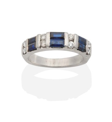 Lot 2128 - A Sapphire and Diamond Half Hoop Ring, three pairs of baguette cut sapphires spaced by pairs of...