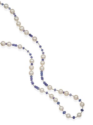 Lot 2129 - A Tanzanite and Cultured Pearl Necklace, faceted tanzanite beads spaced at intervals by groups...