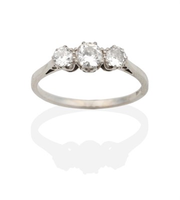 Lot 2131 - A Diamond Three Stone Ring, graduated old cut diamonds in claw settings, to knife edge...