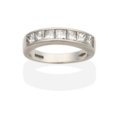 Lot 2136 - A Platinum Princess Cut Diamond Half Hoop Ring, seven princess cut diamonds in a channel...