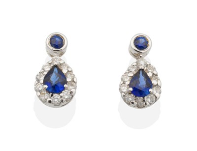 Lot 2138 - A Pair of 18 Carat White Gold Sapphire and Diamond Cluster Earrings, a round cut sapphire in a...