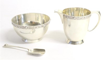 Lot 2201 - A Silver Cream Jug, Sugar Bowl and Spoon, Reid & Sons Ltd, London 1938, with Celtic knot design...