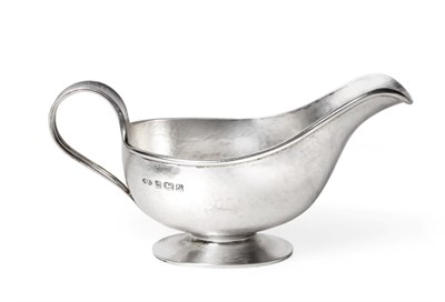 Lot 2204 - An Arts and Crafts Style Silver Sauceboat, A E Jones, Birmingham 1937, with planished finish,...