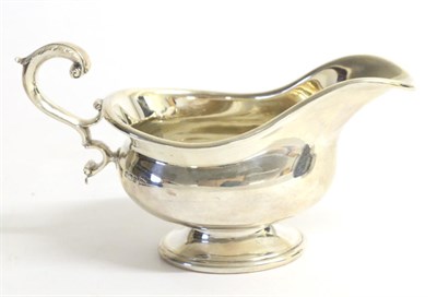 Lot 2225 - A Late Victorian Silver Pedestal Sauceboat, Walker & Hall, Sheffield, 1899, with flying scroll...