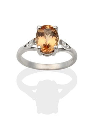 Lot 2005 - An 18 Carat White Gold Imperial Topaz and Diamond Ring, an oval cut topaz in a claw setting, to...