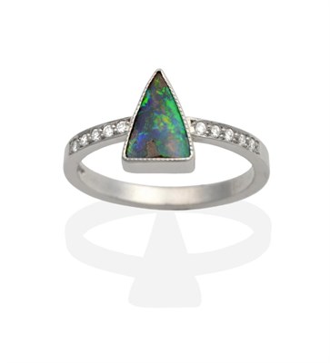 Lot 2013 - An 18 Carat White Gold Boulder Opal and Diamond Ring, a triangular cabochon boulder opal in a...