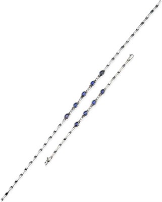 Lot 2015 - A Sapphire Necklace and Bracelet Suite, oval cut sapphires in rubbed over settings, spaced by...