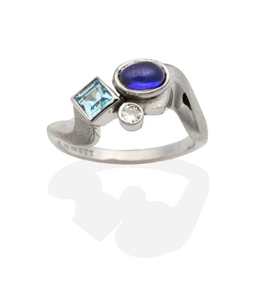 Lot 2016 - A 9 Carat White Gold Multi-Gemstone Ring, an oval cabochon iolite, a square cut blue topaz and...