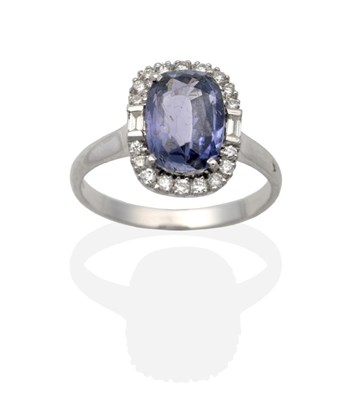 Lot 2042 - An 18 Carat White Gold Synthetic Colour Change Sapphire and Diamond Cluster Ring, an oval cut...