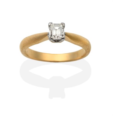 Lot 2050 - An 18 Carat Gold Millennium Cut Solitaire Diamond Ring, in a claw setting, to knife edge shoulders