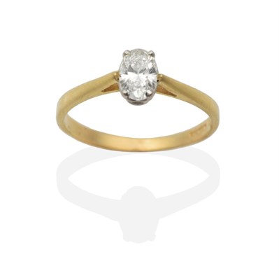 Lot 2052 - An 18 Carat Gold Oval Cut Solitaire Diamond Ring, in a claw setting, to knife edge shoulders,...