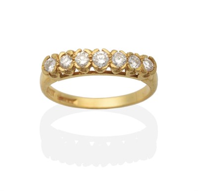 Lot 2054 - An 18 Carat Gold Diamond Half Hoop Ring, seven round brilliant cut diamonds in rubbed over...