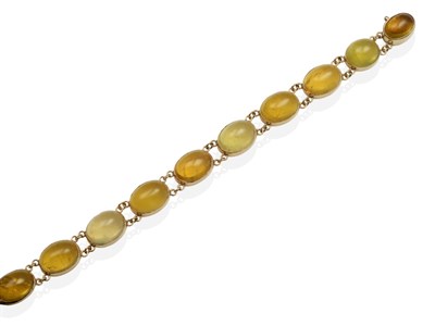 Lot 2076 - A 9 Carat Gold Yellow Beryl Bracelet, ten graduated oval cabochon yellow beryl in rubbed over...