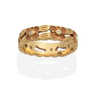 Lot 2077 - An 18 Carat Gold Band Ring, a pierced band with rose coloured flower heads, each set with a...