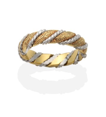 Lot 2084 - An 18 Carat Yellow and White Gold Textured Twist Band Ring, by Jack Spencer, finger size M see...