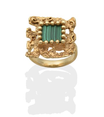 Lot 2092 - A Malachite Ring, a square malachite plaque in a beaded claw setting, within a textured square...