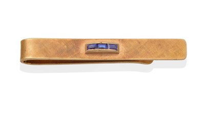 Lot 2094 - A Sapphire Tie Bar, by Tiffany & Co, three calibré cut sapphires in rubbed over settings to...