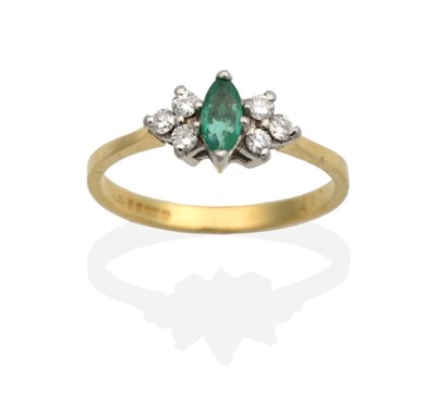 Lot 2105 - An 18 Carat Gold Emerald and Diamond Ring, a marquise cut emerald in a claw setting, spaced by...