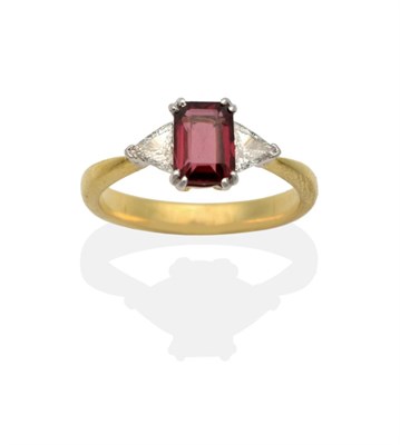 Lot 2107 - A Garnet and Diamond Three Stone Ring, an octagonal cut garnet in a double claw setting, spaced...