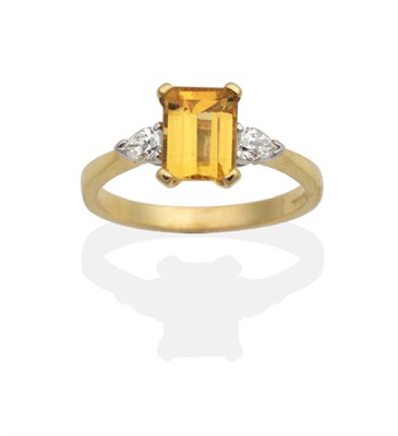 Lot 2109 - An 18 Carat Gold Yellow Beryl and Diamond Three Stone Ring, an octagonal cut yellow beryl in a claw