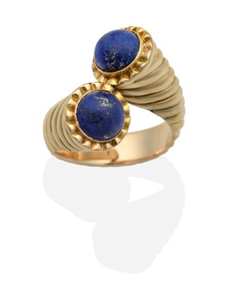 Lot 2112 - A Lapis Lazuli Torque Ring, two round cabochon lapis lazuli in rubbed over settings, to a...