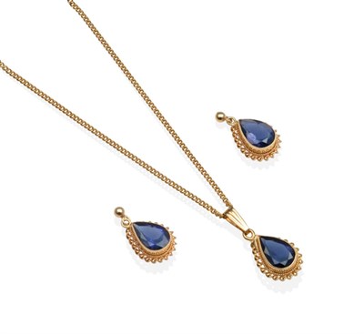 Lot 2113 - A 9 Carat Gold Iolite Pendant and Earring Suite, a pear cut iolite in a milgrain setting, to a rope