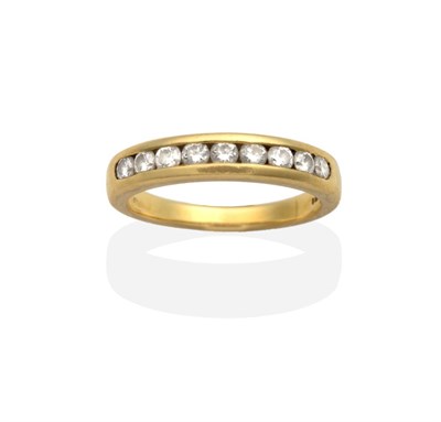 Lot 2116 - An 18 Carat Gold Diamond Half Hoop Ring, channel set with nine round brilliant cut diamonds,...