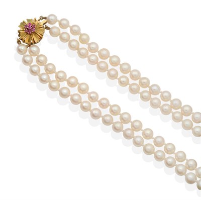 Lot 2122 - A Cultured Pearl Necklace, with a Ruby set Clasp, two strands of uniform cultured pearls knotted to