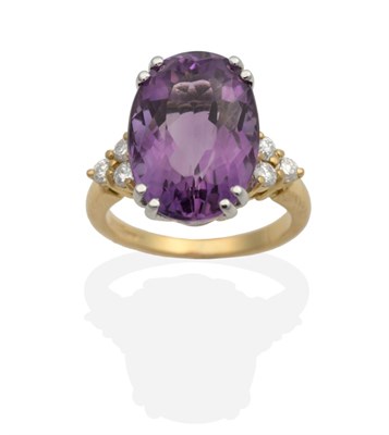 Lot 2125 - An 18 Carat Gold Amethyst and Diamond Ring, an oval cut amethyst in a double claw setting, to...