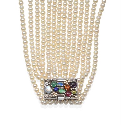 Lot 2127 - A Seven Strand Cultured Pearl Necklace, with a Multi-Gemstone Dorrie Nossiter-Style Clasp,...