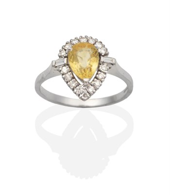 Lot 2128 - An 18 Carat White Gold Yellow Sapphire and Diamond Cluster Ring, a pear cut yellow sapphire in...