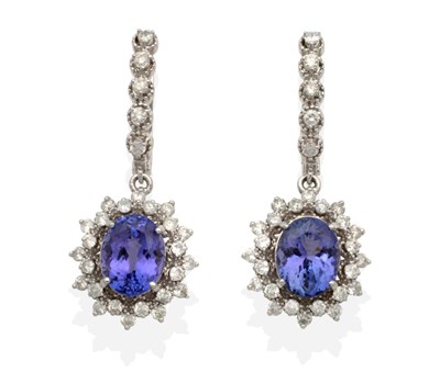 Lot 2138 - A Pair of Tanzanite and Diamond Drop Earrings, a line of articulated round brilliant cut...