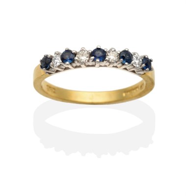 Lot 2140 - An 18 Carat Gold Sapphire and Diamond Half Hoop Ring, round cut sapphires alternate with round...