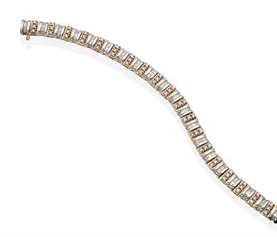 Lot 2143 - A 9 Carat Two Colour Gold Diamond Line Bracelet, yellow gold links set with three round...